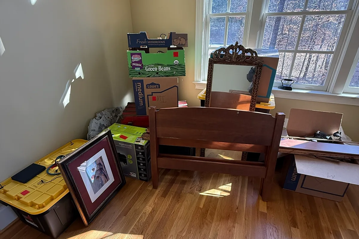 Cluttered bedroom before a whole-house estate cleanout in Marietta, GA